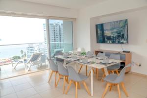 a dining room with a table and chairs at Ocean View Condo with Resort Amenities in Acapulco