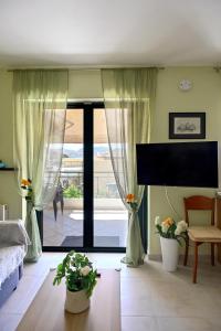 a living room with a large sliding glass door at Melrose maisonette by the sea in Anavissos in Anavyssos