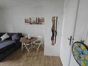 a living room with a couch and a table at Hébergement SARAH in Paris