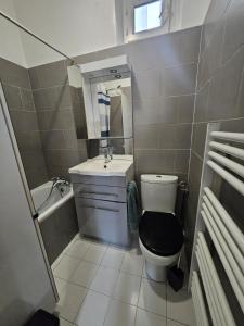 a small bathroom with a toilet and a sink at Hébergement SARAH in Paris