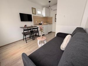 a living room with a couch and a table at Guest House Kiwi Mostar in Mostar