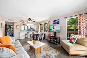 a living room with a couch and a table at KONA - Royal Kahili B205 End Unit - Gorgeous Views in Kailua-Kona