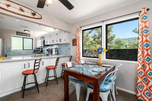 a kitchen and dining room with a table and chairs at KONA - Royal Kahili B205 End Unit - Gorgeous Views in Kailua-Kona