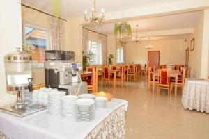 a table with white plates and a coffee maker on it at Willa za Wodą in Zakopane