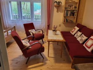 a living room with a couch and chairs and a table at Domek U hřiště in Hlinsko