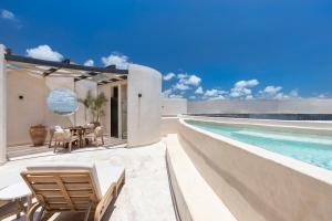 a house with a swimming pool and a patio at Oniric Condo Tulum in Tulum