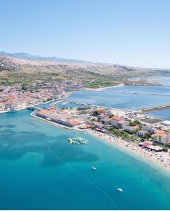 an aerial view of a beach with boats in the water at Modern Panoramic Sea View Apartment with Large Terrace in Pag