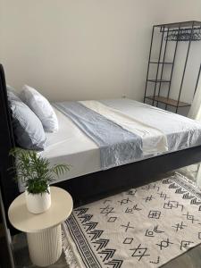 a bedroom with a bed and a table on a rug at Modern Panoramic Sea View Apartment with Large Terrace in Pag