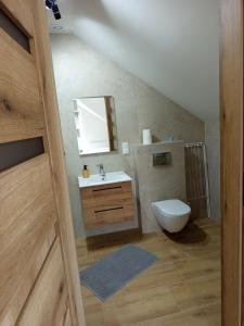 a bathroom with a sink and a toilet at u Harrego in Dębki