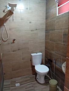 a bathroom with a toilet and a shower at Pousada laranja in Xangri-lá