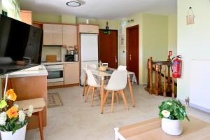 a kitchen with a table and chairs in a room at Melrose maisonette by the sea in Anavissos in Anavyssos +64 photos