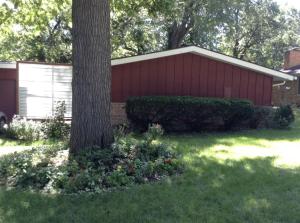 a red building with a tree in the yard at Charming Bedroom with Private Bathroom in Ann Arbor