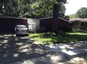 a car parked in the driveway of a house at Charming Bedroom with Private Bathroom in Ann Arbor