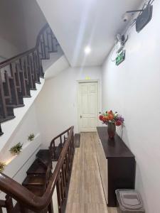 a room with stairs and a vase of flowers on a table at G9 home hotel in Hanoi