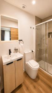 a bathroom with a toilet and a sink and a shower at INT Lisbon Suites in Lisbon +32 photos