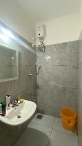 a bathroom with a sink and a toilet and a mirror at Vayangankar House in Belgaum