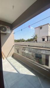 a balcony with a window with a view of a building at Vayangankar House in Belgaum