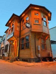 a wooden building on the side of a street at Mirello House Otel Tuzla in Tuzla