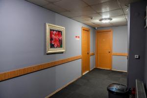 a hallway with a painting of flowers on the wall at Kervan Hotel Pendik in Istanbul