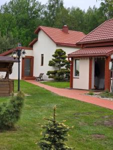 a house with a christmas tree in the yard at D&A Vila - Private Villa with Sauna & Hot Tub in Arciūnai