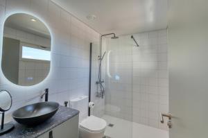 a bathroom with a sink and a toilet and a mirror at Chapelaria Boutique Hotel in Funchal +83 photos