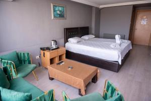 a hotel room with a bed and a table and chairs at Kervan Hotel Pendik in Istanbul +7 photos
