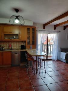a kitchen with a table and chairs in a room at Sun Home Arinaga in Arinaga