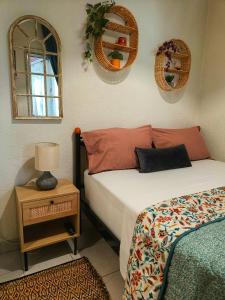 a bedroom with two beds and a table with a lamp at Sailor's Delight in Kavála