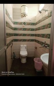a bathroom with a toilet and a sink at Shree mangalam homestay in Bhīm Tāl