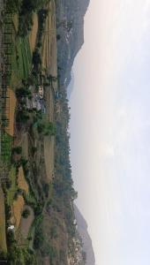 an aerial view of a mountain with a body of water at Shree mangalam homestay in Bhīm Tāl