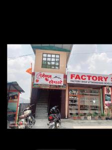 a store with two motorcycles parked in front of it at Shree mangalam homestay in Bhīm Tāl +3 photos