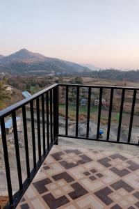 a balcony with a view of the ocean and mountains at Shree mangalam homestay in Bhīm Tāl