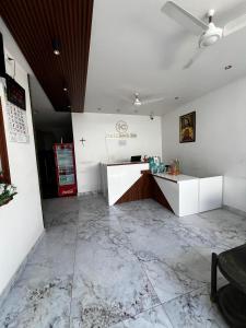 an empty room with a reception desk in a building at Hotel Church Way Inn in Velankanni