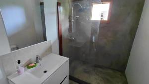 a bathroom with a shower and a sink and a shower at Roça Monte Forte in Neves