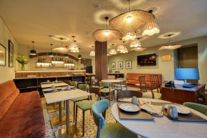a restaurant with tables and chairs and a bar at Chapelaria Boutique Hotel in Funchal