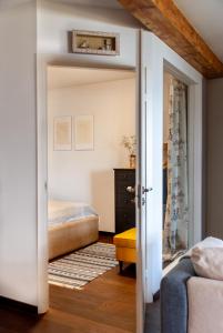 a bedroom with a bed and a door leading into a room at Anties Namai in Juodkrantė