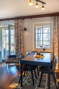 a dining room with a table and chairs at Anties Namai in Juodkrantė
