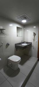a bathroom with a toilet and a sink at Hotel La Costa in Rio de Janeiro