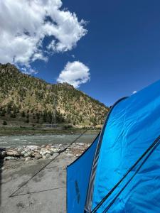 a view of a river from the inside of a tent at Kishan Ganga Camping Site in Wāmpor +12 photos