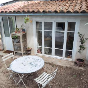 a table and chairs in front of a house at Petite maison en Luberon in Apt