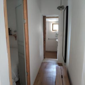 a hallway with a door leading to a bathroom at Petite maison en Luberon in Apt +17 photos