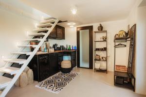a room with a spiral staircase and a kitchen at helloduna in Dunabogdány +11 photos