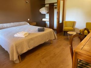 a bedroom with a bed with two towels on it at La maison de Laujol in Moissac