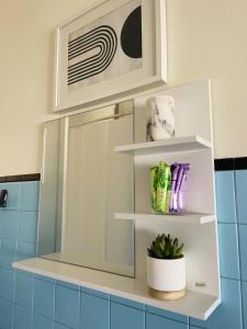 a bathroom with a mirror and a potted plant at Casa de férias in Monte