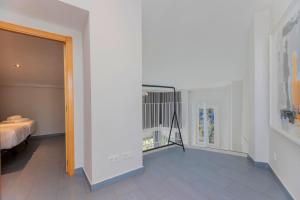 a room with a bed and a hallway at Stancia Carmen in Valencia