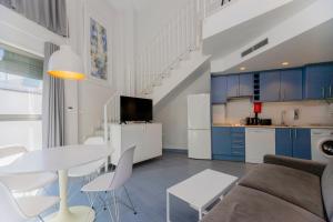 a living room with a couch and a table at Stancia Carmen in Valencia +113 photos