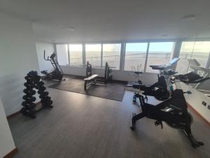 a gym with treadmills and exercise bikes in a room at Studio Distrito Cavancha 2 in Iquique