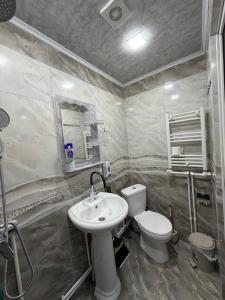 a bathroom with a toilet and a sink at BelGa Guest House in Gyumri +16 photos