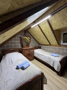 a bedroom with two beds in a attic at BelGa Guest House in Gyumri