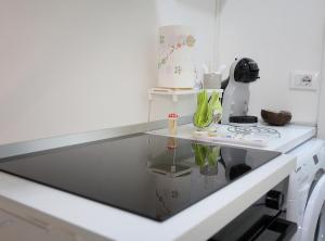 a kitchen with a glass counter top and a stove at Bellamorèa in Noto +27 photos